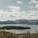 Vibrant summer landscape of Norris Point, NL with lush forests and tranquil lake.